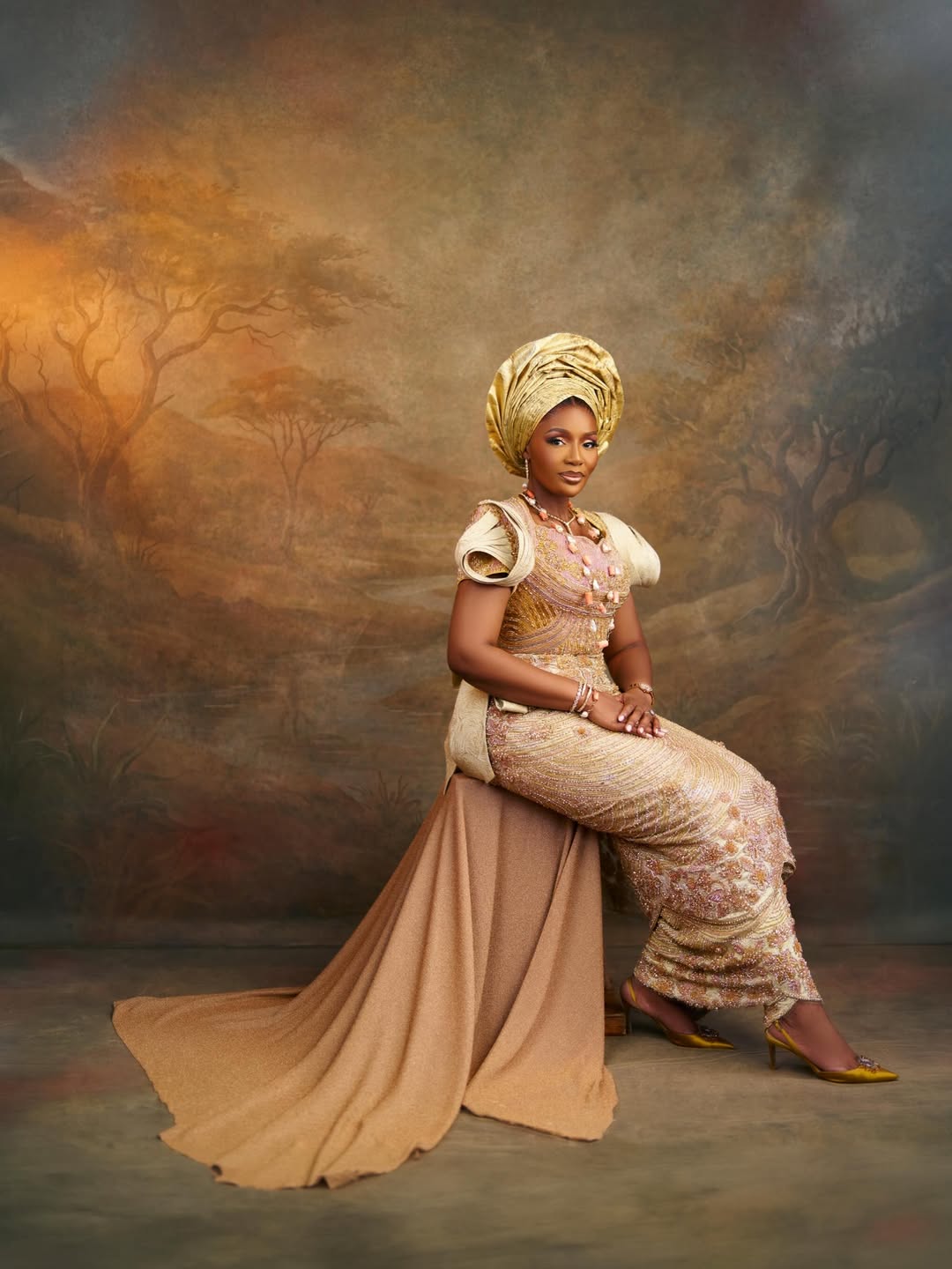 Olori Atuwatse III in a gold traditional ensemble
